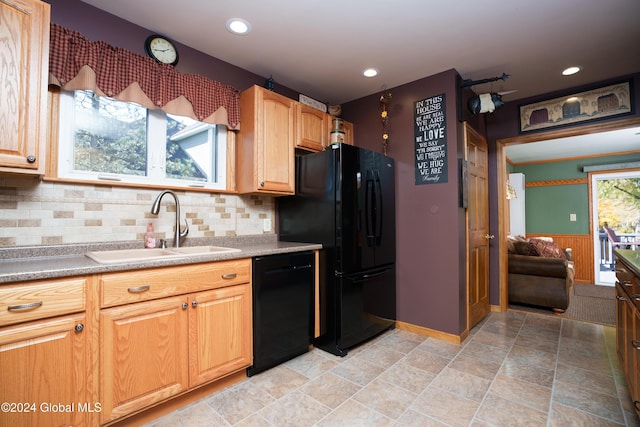 kitchen featuring sink, backsplash, and black appliances