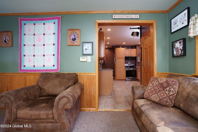 tiled living room featuring wooden walls and crown molding