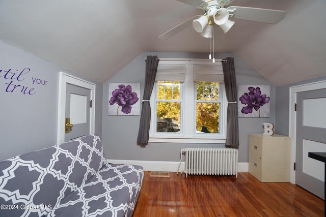 bedroom featuring ceiling fan, dark hardwood / wood-style floors, radiator heating unit, and lofted ceiling