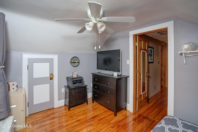 bedroom featuring ceiling fan, light hardwood / wood-style floors, and lofted ceiling