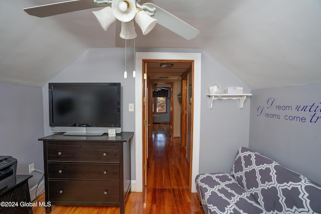 bedroom with ceiling fan, vaulted ceiling, and hardwood / wood-style flooring