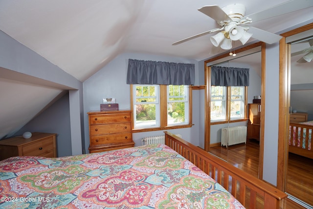 bedroom with radiator heating unit, a closet, ceiling fan, and lofted ceiling