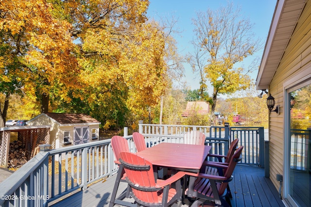 wooden terrace featuring a storage unit