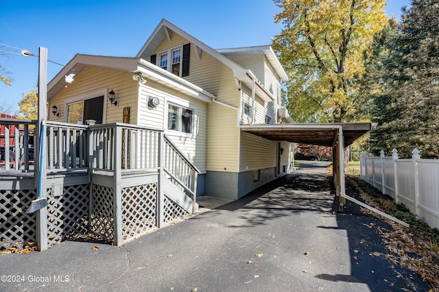 view of property exterior with a carport