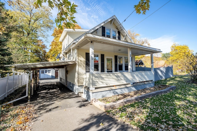 view of front of house with covered porch and a carport