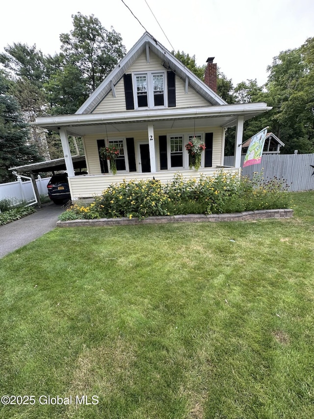 view of front of house with a front yard and a carport