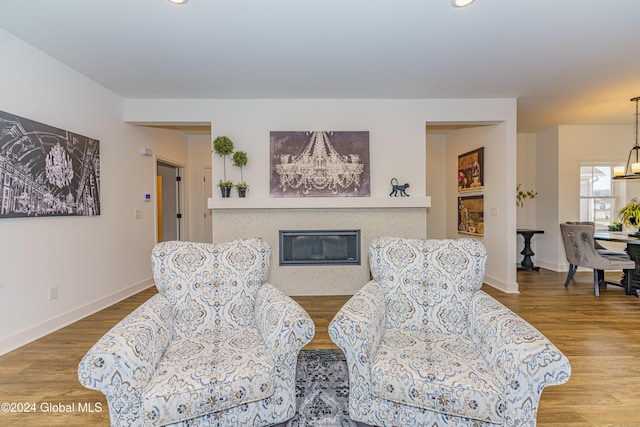 living area with a chandelier and hardwood / wood-style flooring