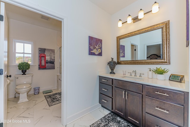 bathroom featuring vanity and toilet
