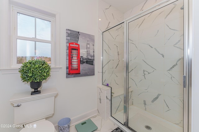 bathroom featuring toilet and a shower with shower door