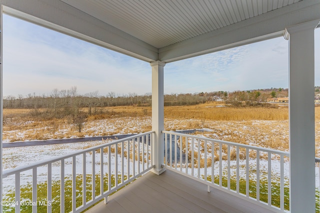wooden terrace featuring a rural view