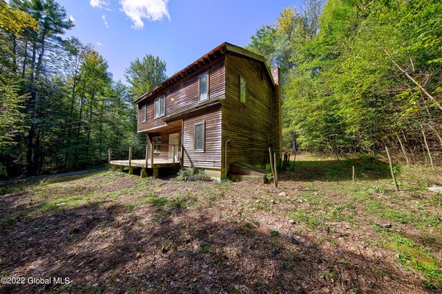 rear view of property featuring a deck