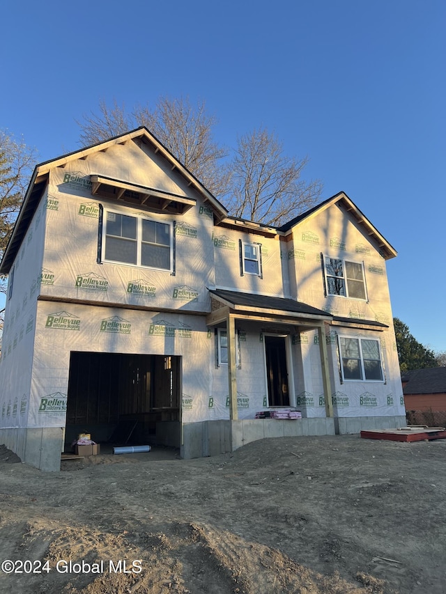 unfinished property featuring a garage