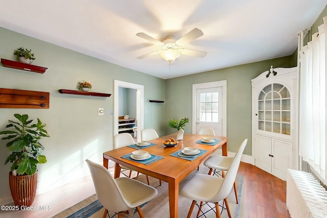 dining area featuring ceiling fan and hardwood / wood-style flooring