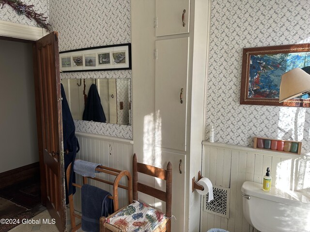 interior space featuring visible vents, wainscoting, and wallpapered walls