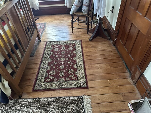 hallway with hardwood / wood-style flooring