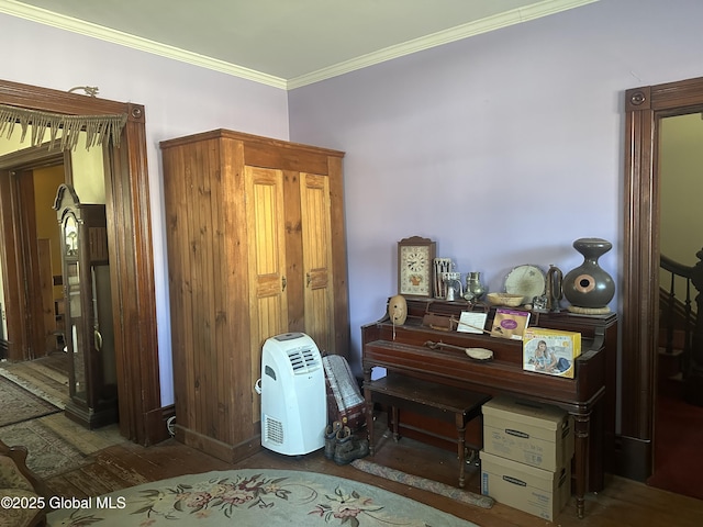 interior space with wood finished floors and ornamental molding