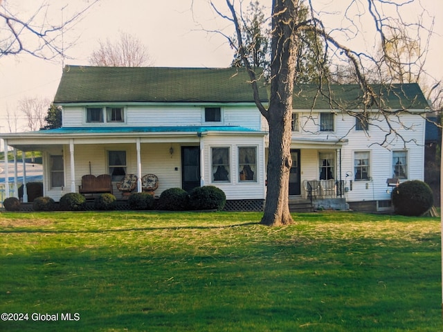 view of front facade with covered porch and a front lawn