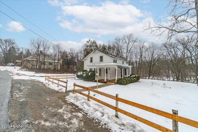 view of snow covered exterior with a porch