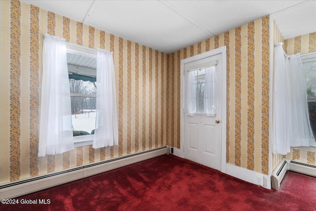 carpeted entryway featuring a baseboard heating unit