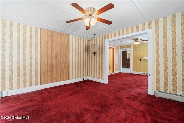 carpeted empty room featuring baseboard heating and ceiling fan