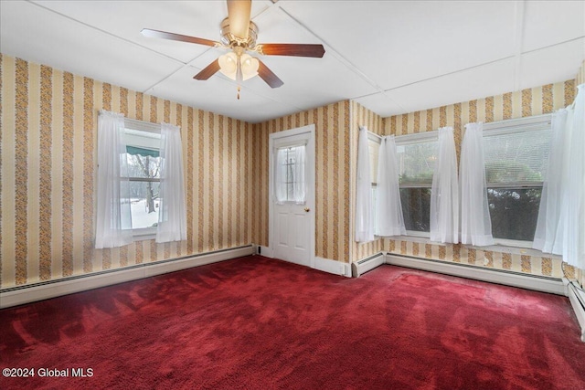 unfurnished room featuring a healthy amount of sunlight, carpet floors, and a baseboard radiator