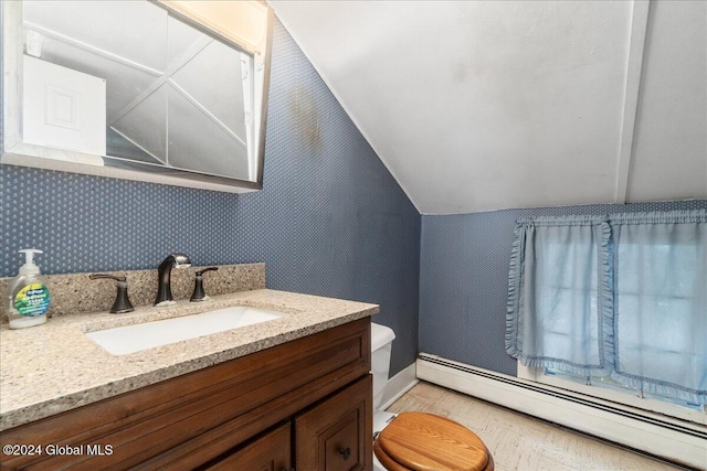 bathroom featuring vanity, toilet, lofted ceiling, and a baseboard radiator