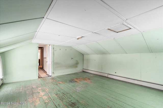 bonus room with hardwood / wood-style floors, lofted ceiling, and a baseboard heating unit