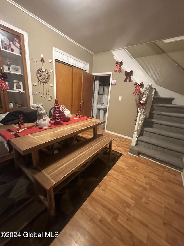 dining area featuring hardwood / wood-style flooring and crown molding