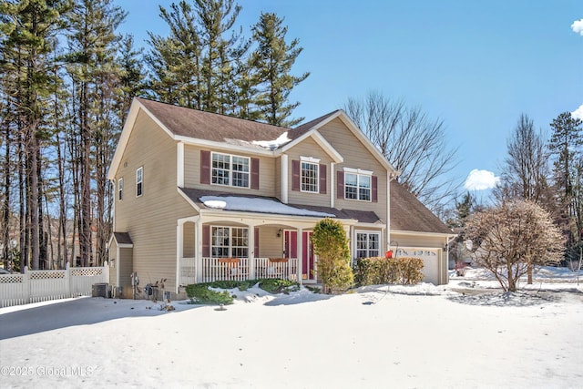 traditional home featuring a garage, central air condition unit, covered porch, and fence