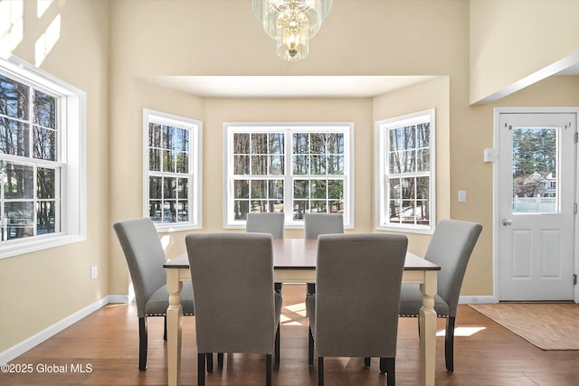 dining room with an inviting chandelier, wood finished floors, and baseboards