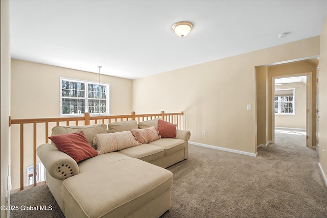 carpeted living area with baseboards