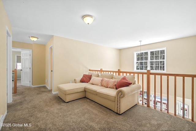 carpeted living area featuring baseboards