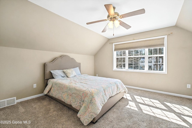 bedroom featuring visible vents, carpet flooring, baseboards, ceiling fan, and vaulted ceiling