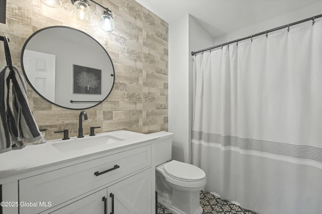 full bathroom featuring toilet, tile walls, and vanity