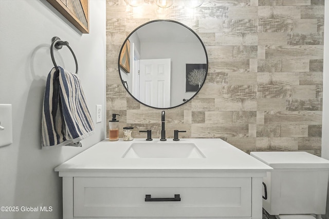 half bathroom featuring tasteful backsplash, toilet, tile walls, and vanity