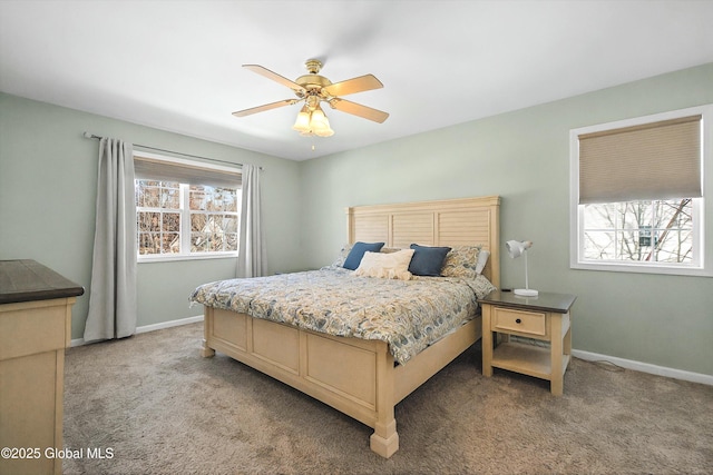 bedroom featuring light colored carpet, baseboards, and ceiling fan