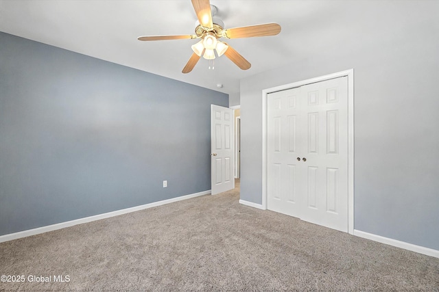 unfurnished bedroom featuring a closet, carpet flooring, a ceiling fan, and baseboards