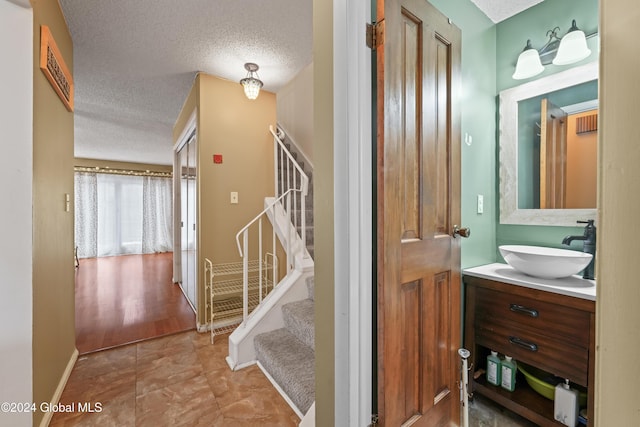 bathroom with vanity and a textured ceiling