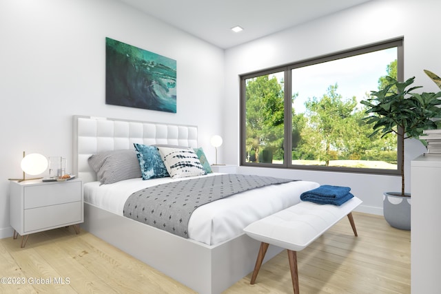 bedroom with light wood-type flooring and baseboards