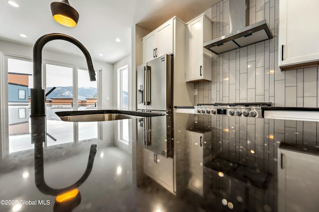 kitchen with stainless steel gas stovetop, white cabinetry, a mountain view, and wall chimney exhaust hood