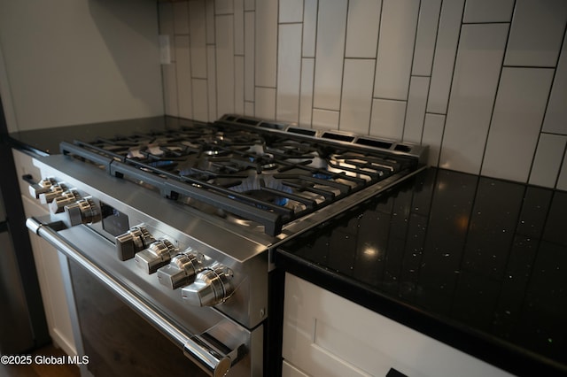 room details featuring dark countertops and high end stove