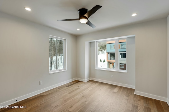 unfurnished room featuring a ceiling fan, light wood-type flooring, baseboards, and recessed lighting