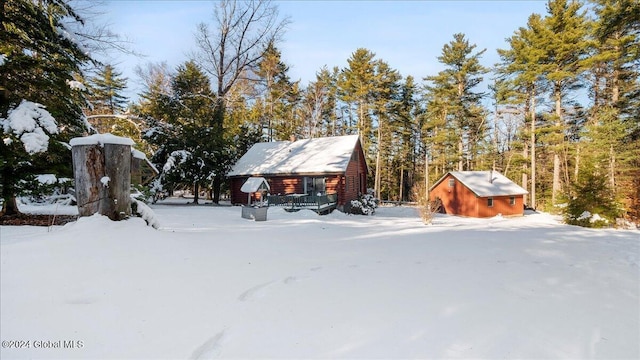 snowy yard featuring an outdoor structure