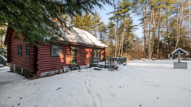 view of snowy exterior with a deck