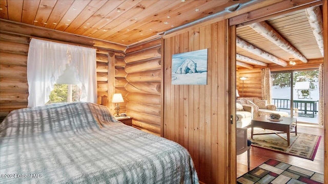 bedroom featuring rustic walls, access to exterior, beamed ceiling, hardwood / wood-style floors, and wood ceiling