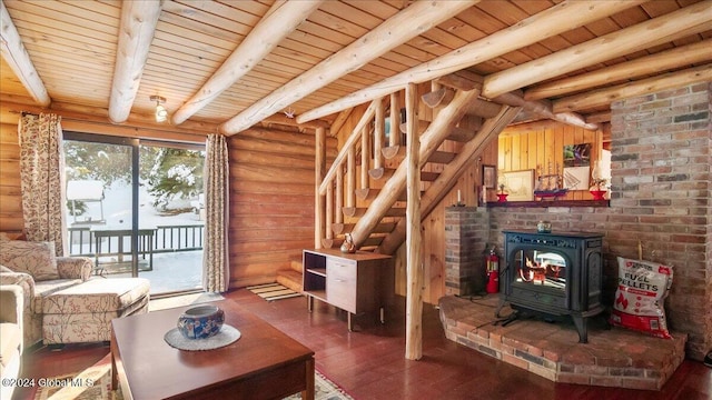 living room featuring a wood stove, dark wood-type flooring, and wooden ceiling