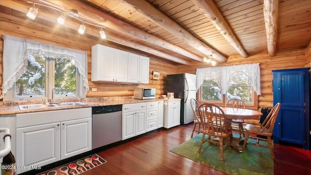 kitchen with sink, beamed ceiling, dark hardwood / wood-style floors, white cabinets, and appliances with stainless steel finishes