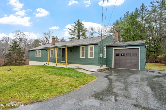 single story home with a garage and a front lawn