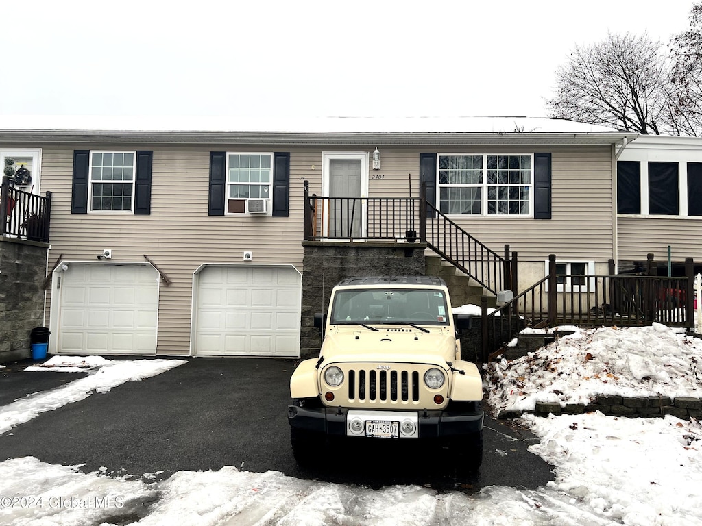 view of front of house with cooling unit and a garage