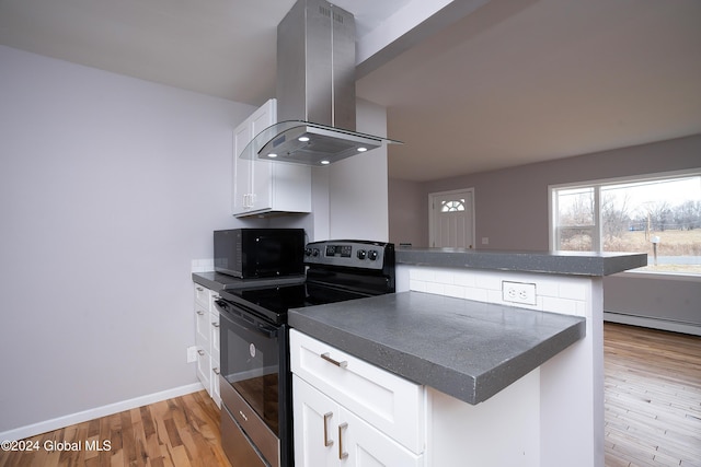 kitchen featuring white cabinets, electric stove, kitchen peninsula, and extractor fan